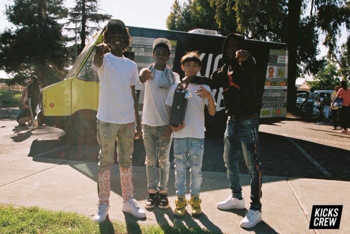 Kids pose with shoes.